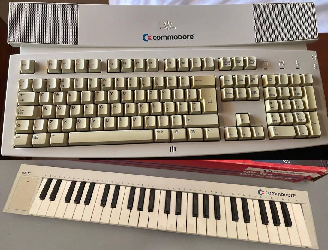 A Commodore-branded computer keyboard with built-in speakers, and a Commodore-branded midi keyboard.
