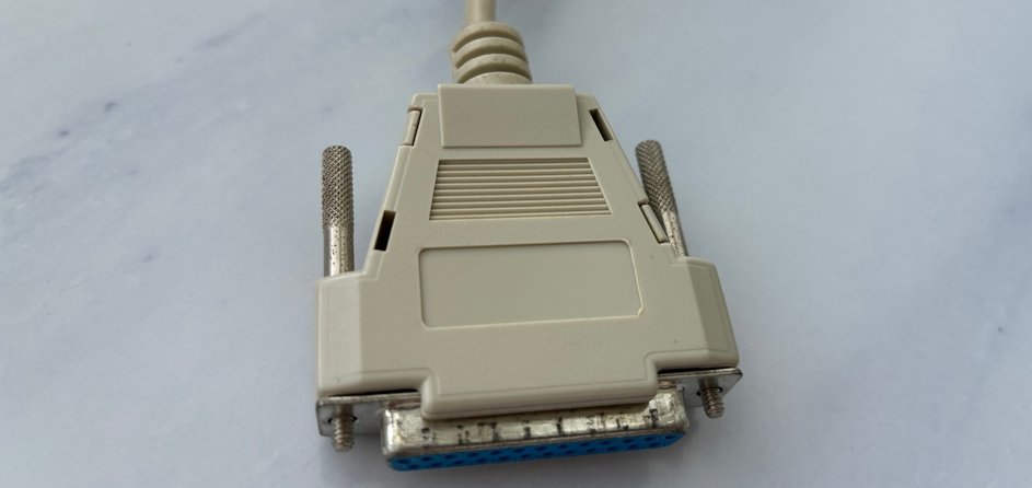 A close-up of a 25-pin D-sub connector with jackscrews for fastening it to the backplane of a computer.